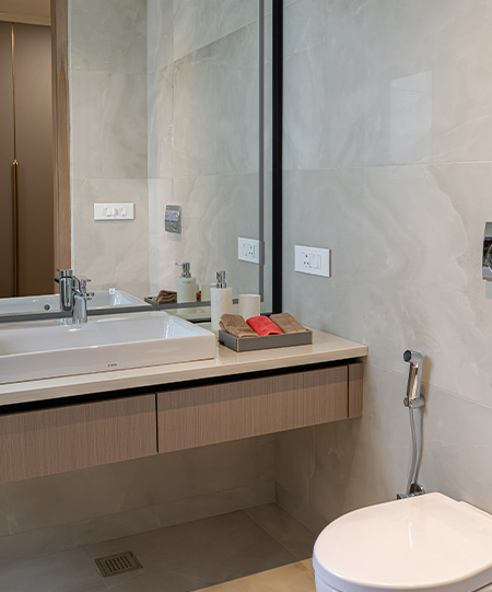 Elegant Casa Homes bathroom with a freestanding bathtub, wooden vanity with vessel sink, and warm ambient lighting enhancing the relaxing mood.